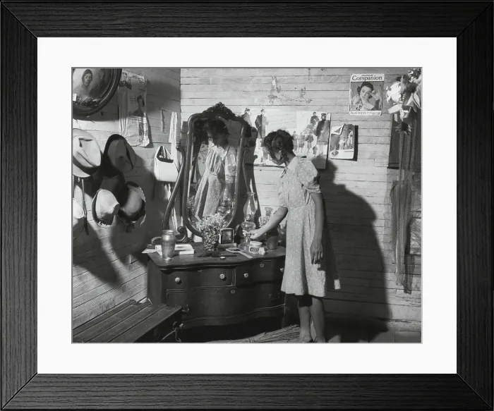 Framed Print : African American women at her dressing table in Putman, Georgia, 1941. The walls are decorated with family portraits and magazine advertisements. (BSLOC_2013_8_124)