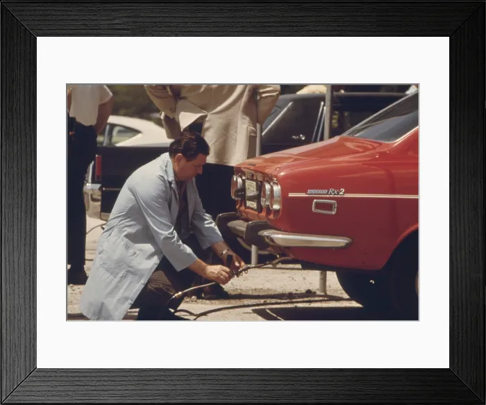 Framed Print : An inspector testing the exhaust of an automobile in Chicago a voluntary auto emissions testing program in 1973