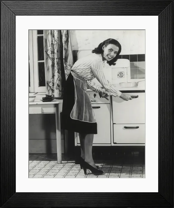 Framed Print : African American actress Lena Horne at a gas stove. She was promoted fuel conservation during World War 2, ca. 1942-45. (BSLOC_2013_14_160)