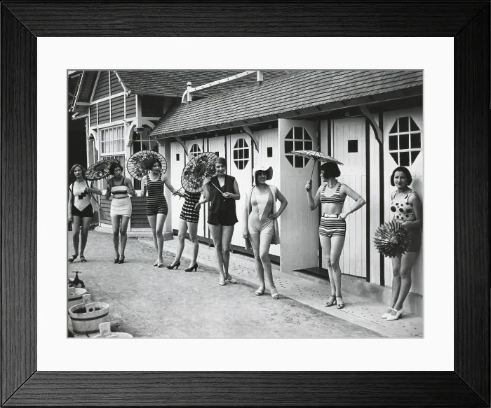 Framed Print : French women pose in the latest fashionable bathing suits outside their beach cabanas at Dieppe. Ca. 1925. (BSLOC_2015_17_203) Framed Print : French women pose in the latest fashionable bathing suits outside their beach cabanas at Dieppe. Ca. 1925. (BSLOC_2015_17_203)