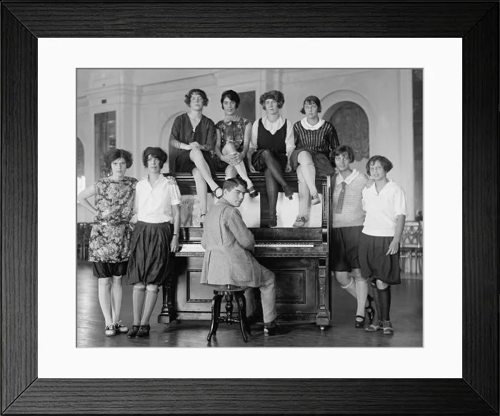 Framed Print : Group of young women described as Debutantes wearing bloomers around a man at a piano. Oct 8, 1923. Washington, D.C. vicinity, (BSLOC_2015_17_209)