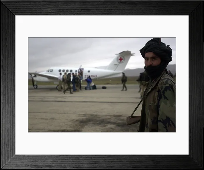 Framed Print : In Afghanistan a Northern Alliance soldier provides security to the Mazir-e Sharif civilian airfield during the landing of a Red Cross aircraft Dec. 11 2001