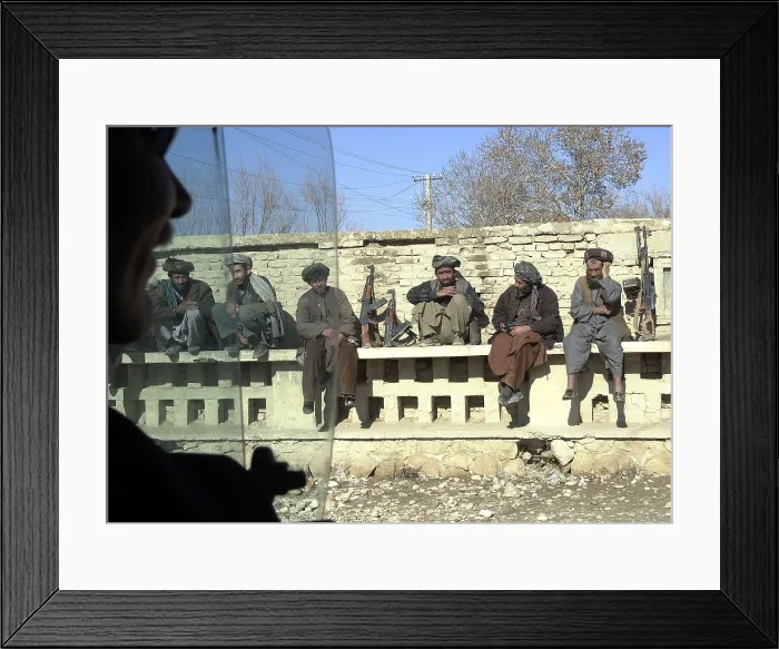 Framed Print : Northern Alliance troops under General Dostum's command in Mazar-e Sharif take a break on a wall in the median of the town's busiest street