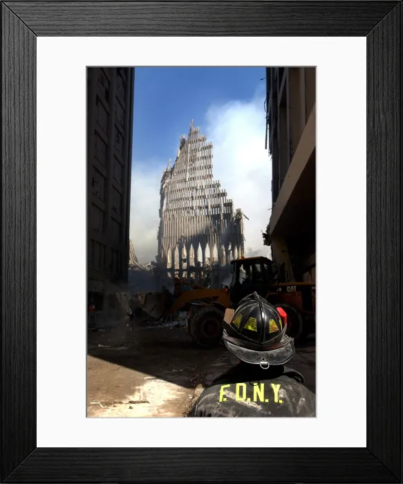 Framed Print : A New York City firefighter stands before a still standing section of the World Trade Center after the Sept. 11th terrorist attacks. Sept. 13 2001, Photo by: Everett Collection