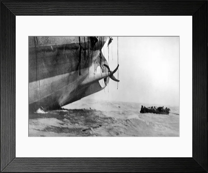 Framed Print : Sailors escape from vessel torpedoed by German submarine in World War I. The ship's bow has already sunk into the waves, and the stern is lifting out of the water Framed Print : Sailors escape from vessel torpedoed by German submarine in World War I. The ship's bow has already sunk into the waves, and the stern is lifting out of the water