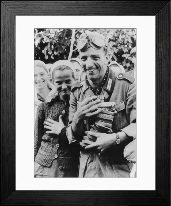 Framed Print : German soldier holding an armful of sliced bread with several young Ukrainian women. German propaganda photo of welcoming Ukrainians during Operation Barbarossa invasion. Oct