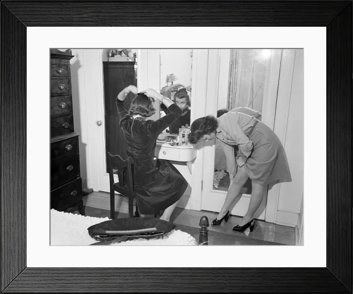 Framed Print : Young women dressing up in Detroit, Michigan. One is straightening her stocking seams, while another girl combs her hair at a mirror. Summer, 1941. (BSLOC_2013_14_184) Framed Print : Young women dressing up in Detroit, Michigan. One is straightening her stocking seams, while another girl combs her hair at a mirror. Summer, 1941. (BSLOC_2013_14_184)