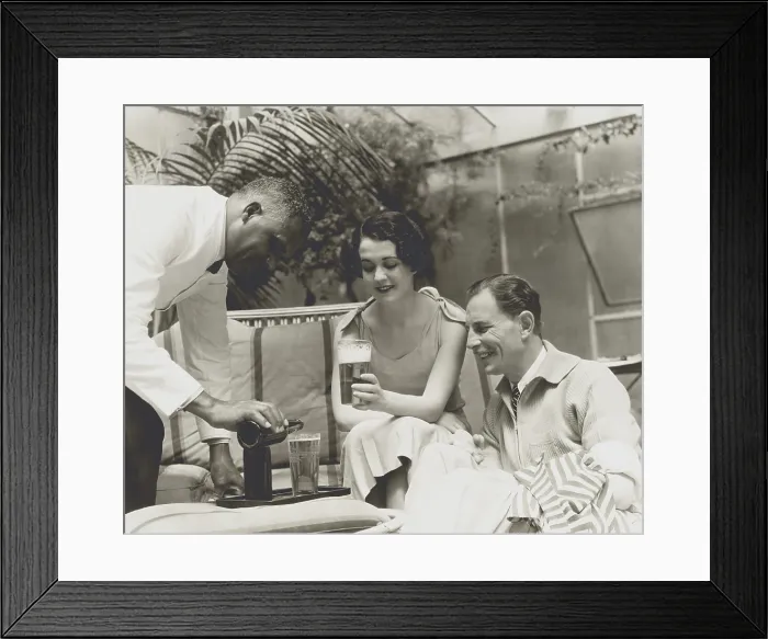 Framed Print : Couple served beer in a 1933 advertising photo for a brewer. (BSLOC_2013_8_155)
