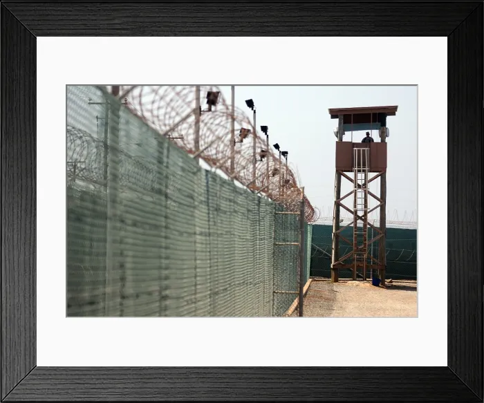 Framed Print : U.S. Soldier stands watch in a guard tower at Camp Delta in Guantanamo Bay Naval Base Cuba June 8 2010. Photo by:Everett Collection(BSLOC_2011_6_154) Framed Print : U.S. Soldier stands watch in a guard tower at Camp Delta in Guantanamo Bay Naval Base Cuba June 8 2010. Photo by:Everett Collection(BSLOC_2011_6_154)