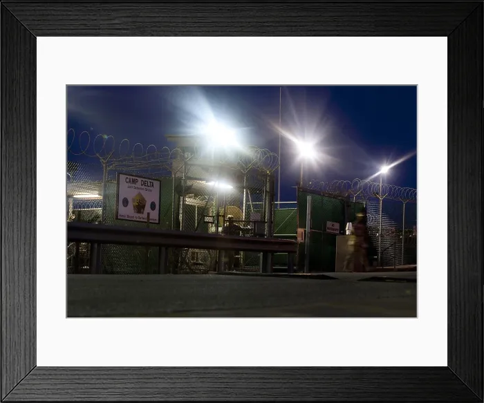 Framed Print : U.S. Sailor exits a controlled entryway after completing a 12-hour shift at Camp Delta Guantanamo Bay Naval Base Cuba June 9 2010. Photo by:Everett Collection(BSLOC_2011_6_156)