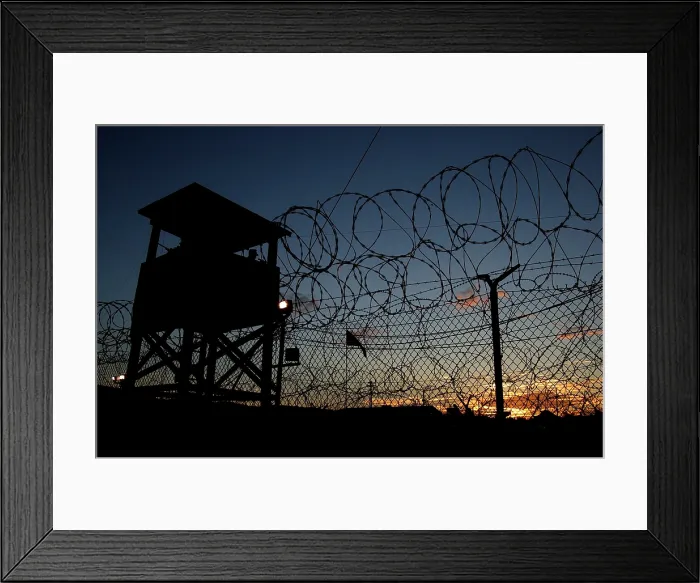 Framed Print : The sun sets on Camp X-Ray's first day as an active compound on Jan. 11 2002