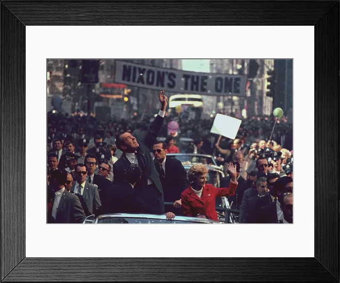 Framed Print : Nixon 1968 Presidential Campaign. Richard and Pat Nixon wave to the Philadelphia crowds. A huge banner reading Nixon's the One is stretched across Chestnut Street
