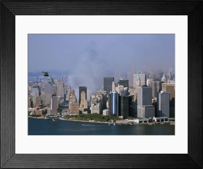 Framed Print : Smoke from the ruins of the World Trade Center two days after the 9 / 11 terrorists attacks north of New York City's Battery Part and Financial District office buildings. Sept