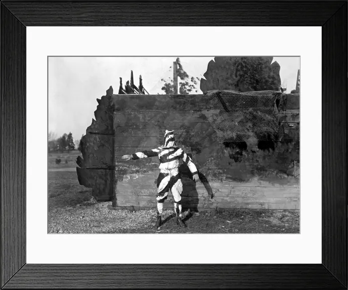 Framed Print : American World War I soldier in black and white uniform to conceal him while climbing trees. He stands in front of a house camouflaged to represent a fence and trees. Nov Framed Print : American World War I soldier in black and white uniform to conceal him while climbing trees. He stands in front of a house camouflaged to represent a fence and trees. Nov