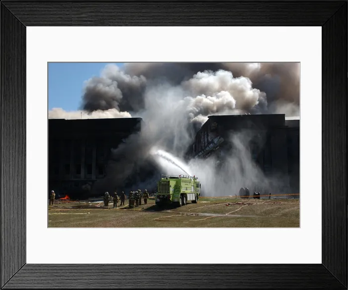 Framed Print : Firefighters work to put out the flames moments after a hijacked jetliner crashed into the Pentagon at approximately 9 30 AM on Sept
