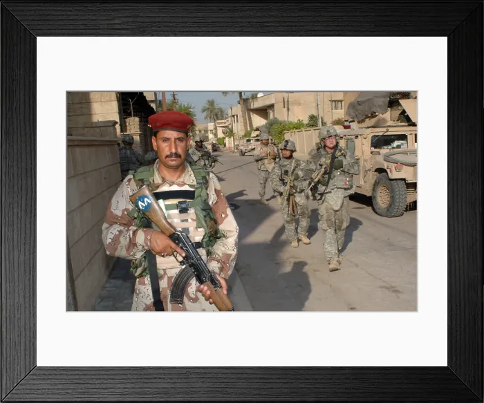 Framed Print : An Iraqi soldier leads the way during a search operation with US Army soldiers in the Rusafa area of Baghdad Iraq June 19 2007. (BSLOC_2011_12_156)