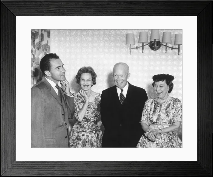 Framed Print : Vice President and Republican Nominee for President Richard Nixon adjusting his collar. Pat Nixon, President and Mamie Eisenhower appear amused. Aug. 24, 1960