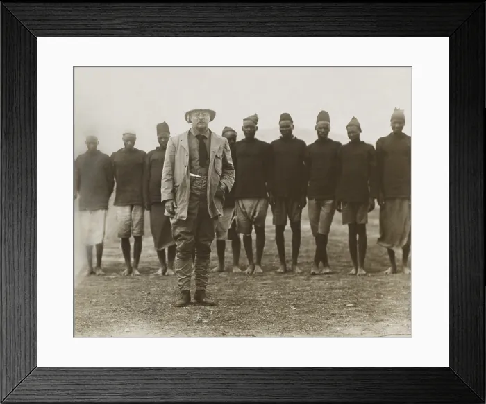 Framed Print : Theodore Roosevelt standing in front of African men working for his safari. They served as porters, cooks, on hunts, and specimen collection tasks