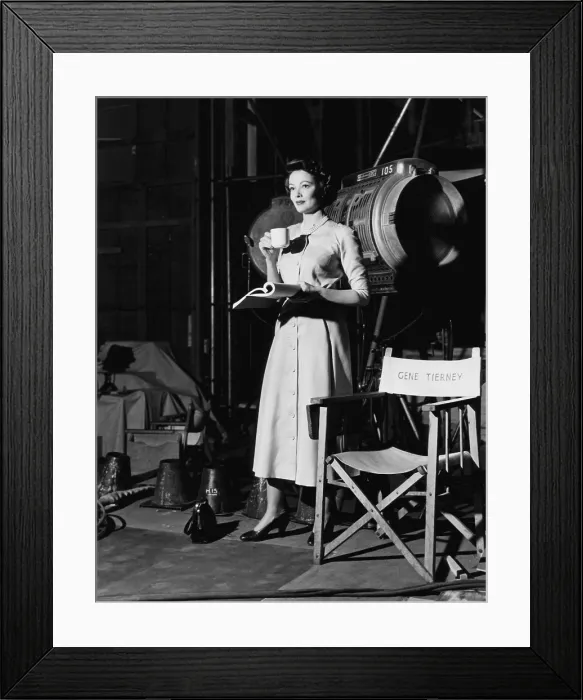 Framed Print : PERSONAL AFFAIR, Gene Tierney holding her script and afternoon tea on set, 1953