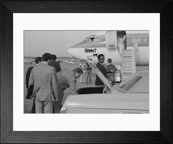 Framed Print : Jimmy Carter retrieving his luggage from a car before boarding Peanut One campaign airplane