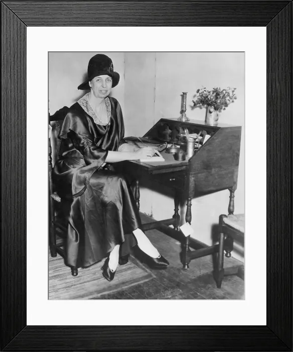 Framed Print : Eleanor Roosevelt in New York City. 1932. She is writing at a desk, dressed in a silk dress with lace collar, cloche hat, and pumps. (BSLOC_2013_5_204) Framed Print : Eleanor Roosevelt in New York City. 1932. She is writing at a desk, dressed in a silk dress with lace collar, cloche hat, and pumps. (BSLOC_2013_5_204)