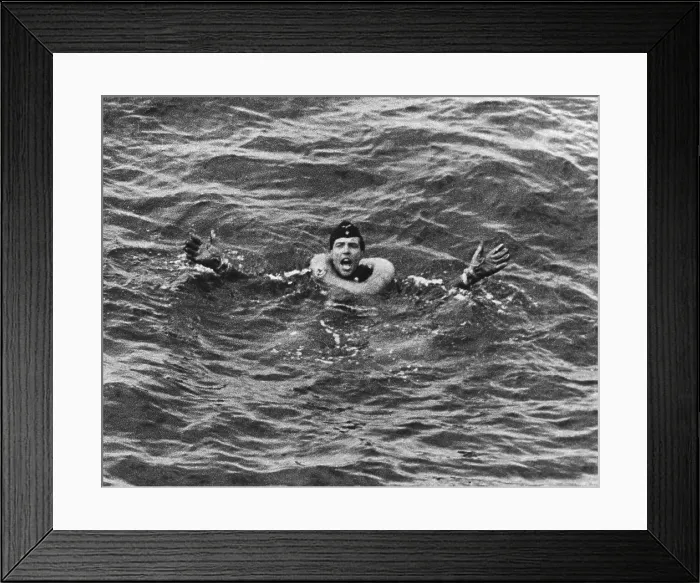 Framed Print : German submariner from U-175 has a life ring around his neck. He gestures for help while awaiting rescue in the Atlantic Ocean during World War 2, ca. 1941-43. (BSLOC_2013_11_112)