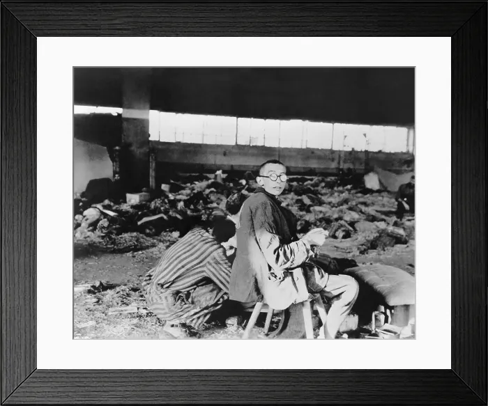 Framed Print : Nordhausen Concentration camp prisoners having a meager meal among the dead. After liberation by U.S Framed Print : Nordhausen Concentration camp prisoners having a meager meal among the dead. After liberation by U.S