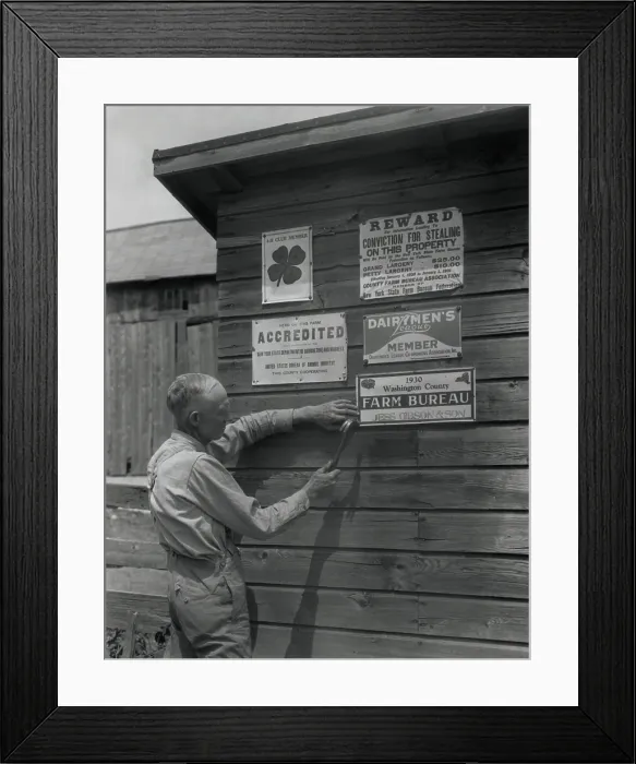Framed Print : Farmer attaches another membership sign to his barn, Washington County, New York, 1930. Agricultural organizations encouraged more effective farming and lessened rural isolation
