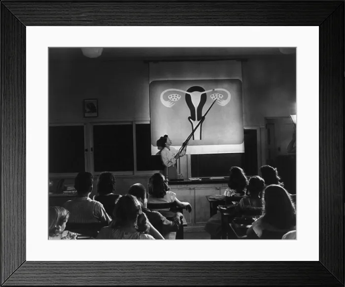 Framed Print : Teacher points to a diagram of female reproductive organs in a Sex Education class. The Oregon junior high students are viewing an educational film, HUMAN GROWTH, in 1948