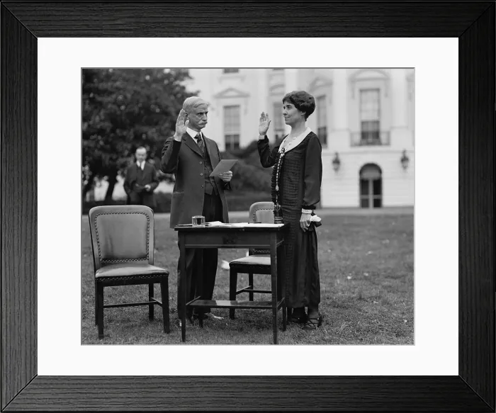 Framed Print : First Lady Grace Coolidge taking an oath before filling out her ballot for the 1924 Election. President Calvin Coolidge stands in the background. (BSLOC_2015_15_117) Framed Print : First Lady Grace Coolidge taking an oath before filling out her ballot for the 1924 Election. President Calvin Coolidge stands in the background. (BSLOC_2015_15_117)