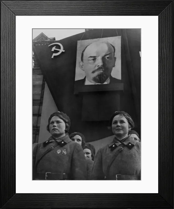 Framed Print : Students of the Military Communications Academy in Red Square, Moscow. Young women in military uniforms parade under a portrait of Lenin. 1930s photo by Georgii Zelma