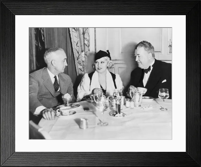 Framed Print : Mae West dining at the Victor Hugo Caf with her manager James Timony (right). At left is John Hammel of New York. 1933. (BSLOC_2013_9_13) Framed Print : Mae West dining at the Victor Hugo Caf with her manager James Timony (right). At left is John Hammel of New York. 1933. (BSLOC_2013_9_13)