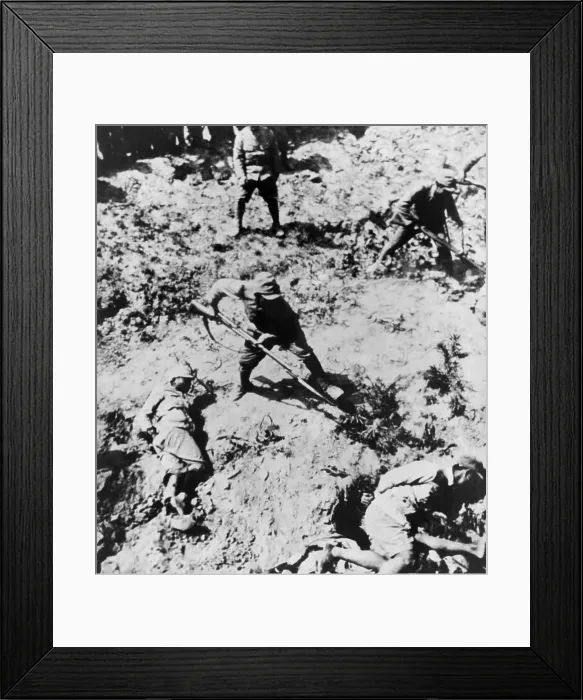 Framed Print : Japanese soldiers with bayonets menacing their Chinese captives. The victims lie on the ground with their hands bound. Between 1937 -1943. (BSLOC_2013_9_119)