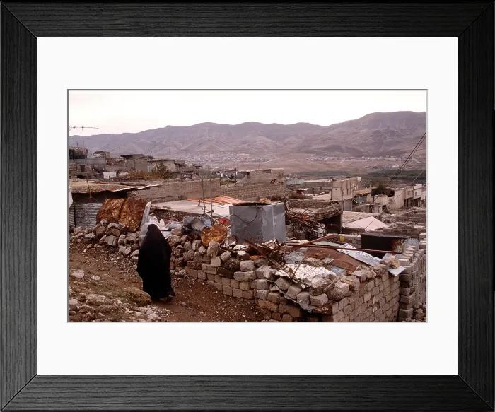 Framed Print : Kurdish resident of Airoshky in northern Iraq walks through her destroyed town after it was bombed by Iraqi President Saddam Hussein's forces. Nov. 18 1991. (BSLOC_2011_12_26)