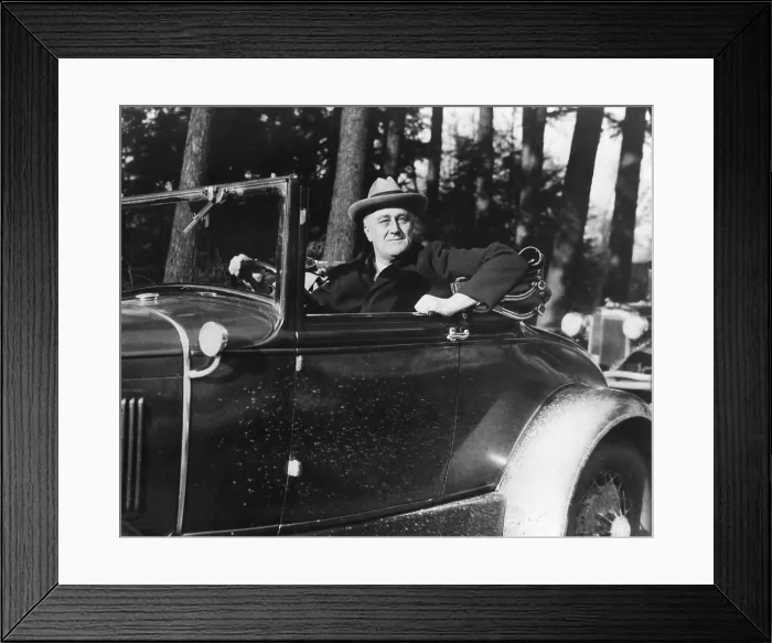 Framed Print : President Franklin Roosevelt driving his car in Hyde Park, New York. 1933. His car was engineered with manual controls replacing foot pedals. (BSLOC_2013_5_105)