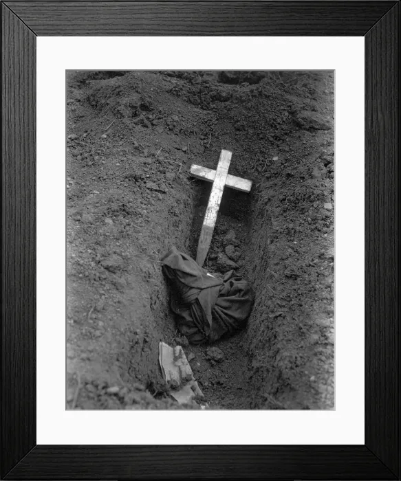 Framed Print : Charred remains of an American POW captured at Bataan by Japanese in May 1942. This is the grave of more than 100 U.S. soldiers who died during captivity