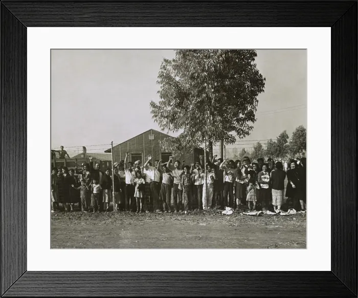 Framed Print : Japanese Americans internees waving farewell from behind a wire fence at Pomona, CA, 1942