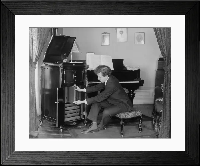 Framed Print : Jascha Heifetz, 17 year old violin virtuoso removing a record album from his Victrola phonograph, c. 1917 (BSLOC_2017_12_35) Framed Print : Jascha Heifetz, 17 year old violin virtuoso removing a record album from his Victrola phonograph, c. 1917 (BSLOC_2017_12_35)