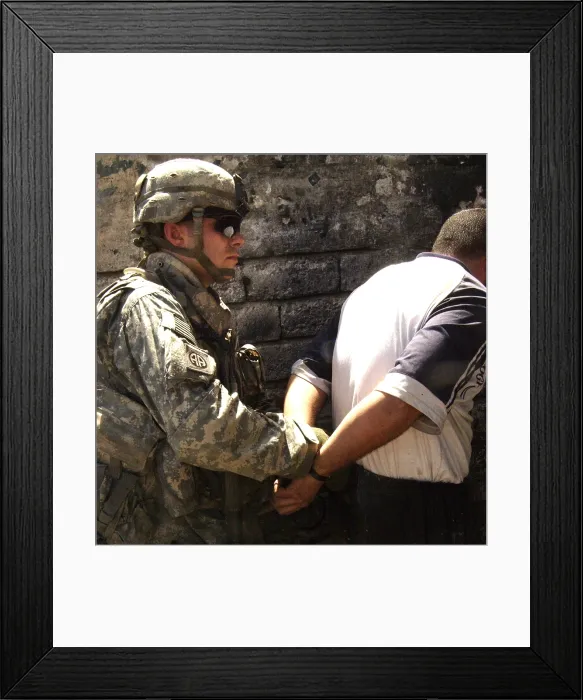 Framed Print : US soldier cuffs an Iraqi man suspected of making improvised explosive devices during the Iraq insurgency. Mosul Iraq. June 5 2007. (BSLOC_2011_12_147) Framed Print : US soldier cuffs an Iraqi man suspected of making improvised explosive devices during the Iraq insurgency. Mosul Iraq. June 5 2007. (BSLOC_2011_12_147)