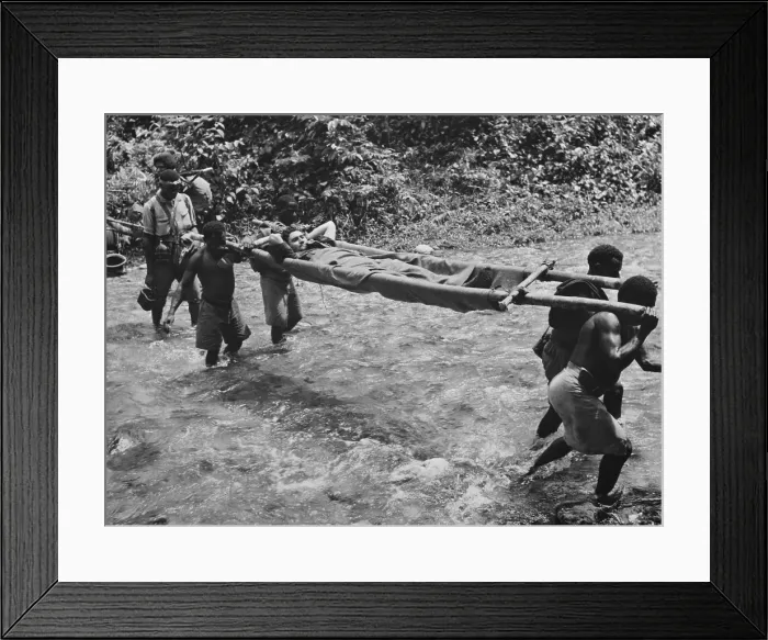 Framed Print : Native carriers transporting Allied (Australian) wounded in the Kokoda campaign. Fought between July and Nov. 1942 in Papua, it resulted in a victory against the Japanese