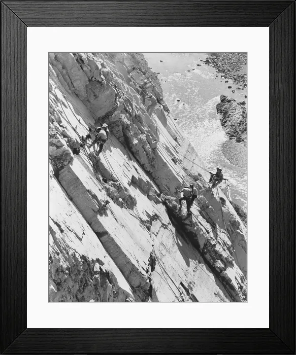 Framed Print : Eight men working high up on rock face of canyon wall, drilling holes for dynamite. They are building Hungry Horse Dam in Montana in 1949. (BSLOC_2014_13_227)