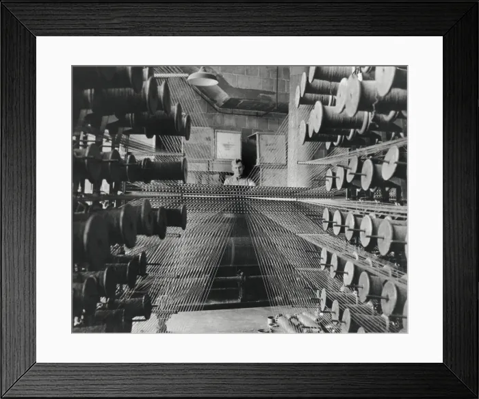 Framed Print : Workman operating an industrial loom strung with hundreds of wool threads. Chicago's Olsen Rug Company. Ca. 1950. (BSLOC_2014_13_232) Framed Print : Workman operating an industrial loom strung with hundreds of wool threads. Chicago's Olsen Rug Company. Ca. 1950. (BSLOC_2014_13_232)