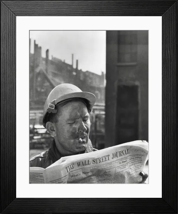 Framed Print : An electrician reads The Wall Street Journal to check his stock market investments Framed Print : An electrician reads The Wall Street Journal to check his stock market investments
