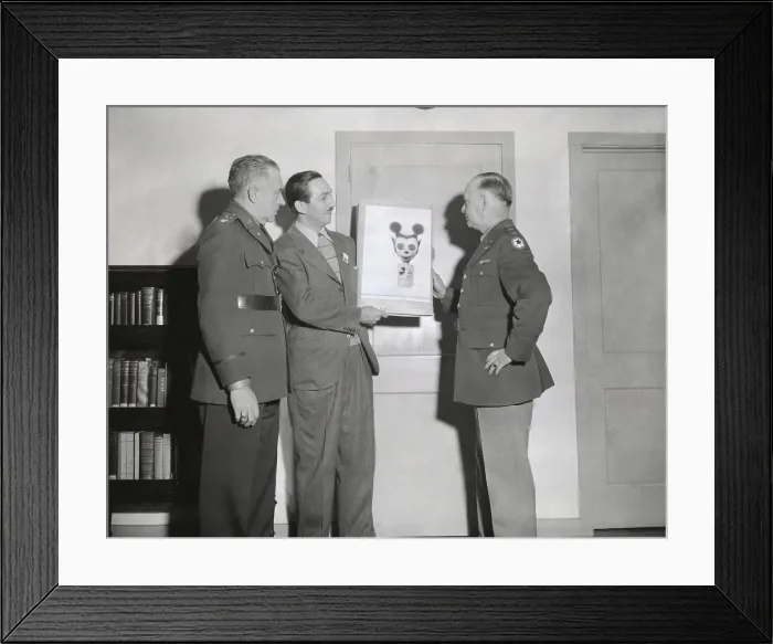 Framed Print : Walt Disney showing a sketch of Mickey Mouse gas mask to Chemical Warfare officer. Gen. William N. Porter, and Civil Defense Chief, Col