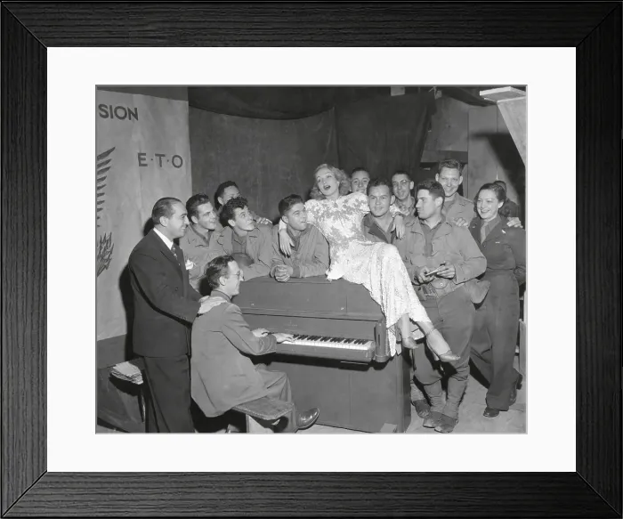 Framed Print : Actress Marlene Dietrich singing for a group of GI's in France. Joey Faye (left), and Jerry Cummings, pianist, accompanied Miss Dietrich, Oct. 18, 1844. (BSLOC_2014_8_206)