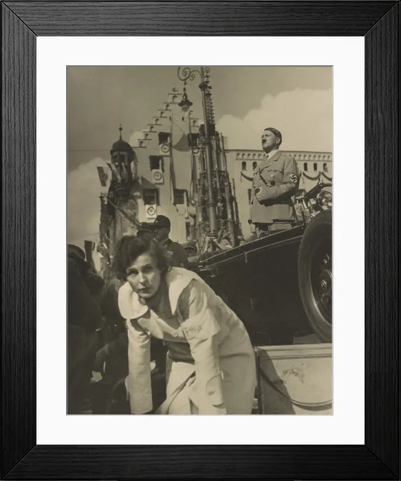 Framed Print : Adolf Hitler standing in an open automobile, with Leni Riefenstahl foreground, facing the camera
