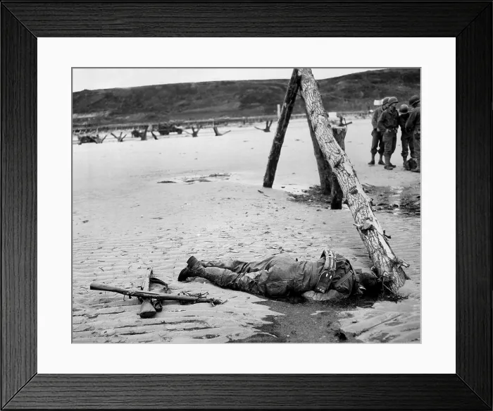 Framed Print : Dead U.S. soldier on Omaha beach on D-Day, June 6, 1944. Crossed rifles in the sand are a comrade's tribute Framed Print : Dead U.S. soldier on Omaha beach on D-Day, June 6, 1944. Crossed rifles in the sand are a comrade's tribute