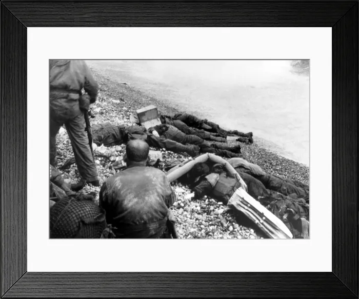 Framed Print : Dead U.S. soldiers Omaha beach on D-Day, June 6, 1944. Some bodies are covered with lifebuoys, and one of them has the face covered by a cardboard box Framed Print : Dead U.S. soldiers Omaha beach on D-Day, June 6, 1944. Some bodies are covered with lifebuoys, and one of them has the face covered by a cardboard box