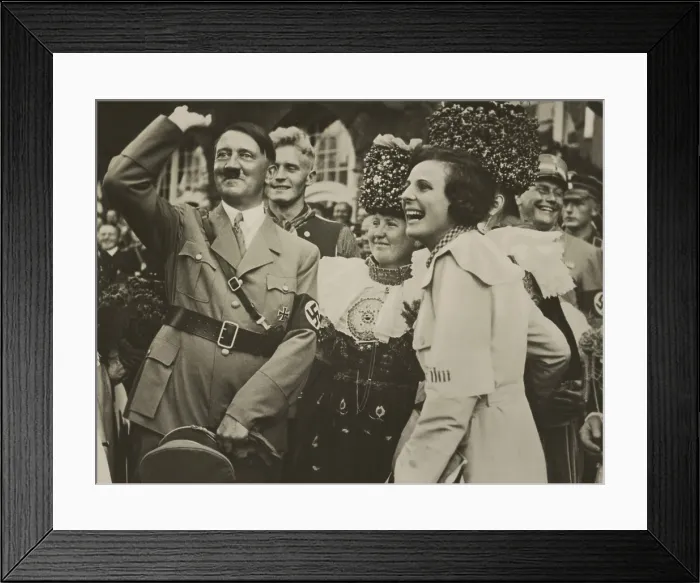 Framed Print : Adolf Hitler and filmmaker, Leni Riefenstahl, with joyous smiles. They are in a group with woman wearing traditional German costumes and uniformed Nazis