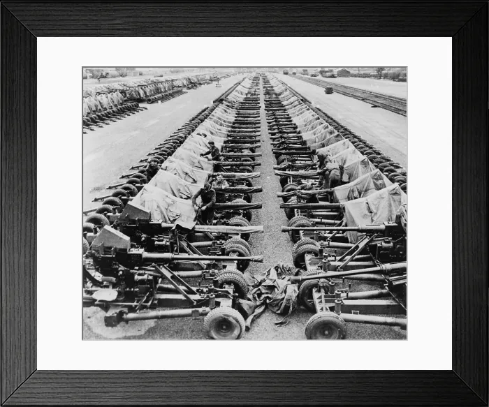 Framed Print : Rows of 40mm Bofors light anti-aircraft guns beside railroad tracks in England Framed Print : Rows of 40mm Bofors light anti-aircraft guns beside railroad tracks in England